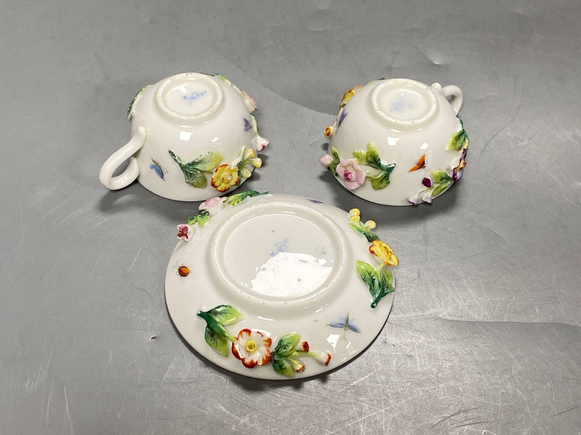 A late 19th century French porcelain flower encrusted cafe au lait set, on stand, stand 27cm